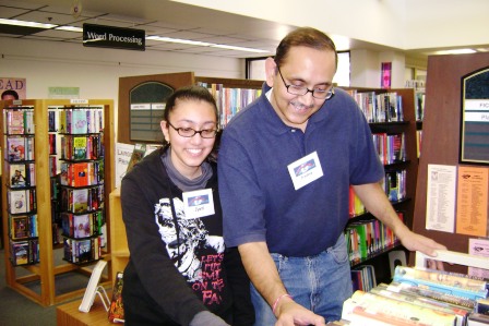 Father and Teen Daughter using the library
