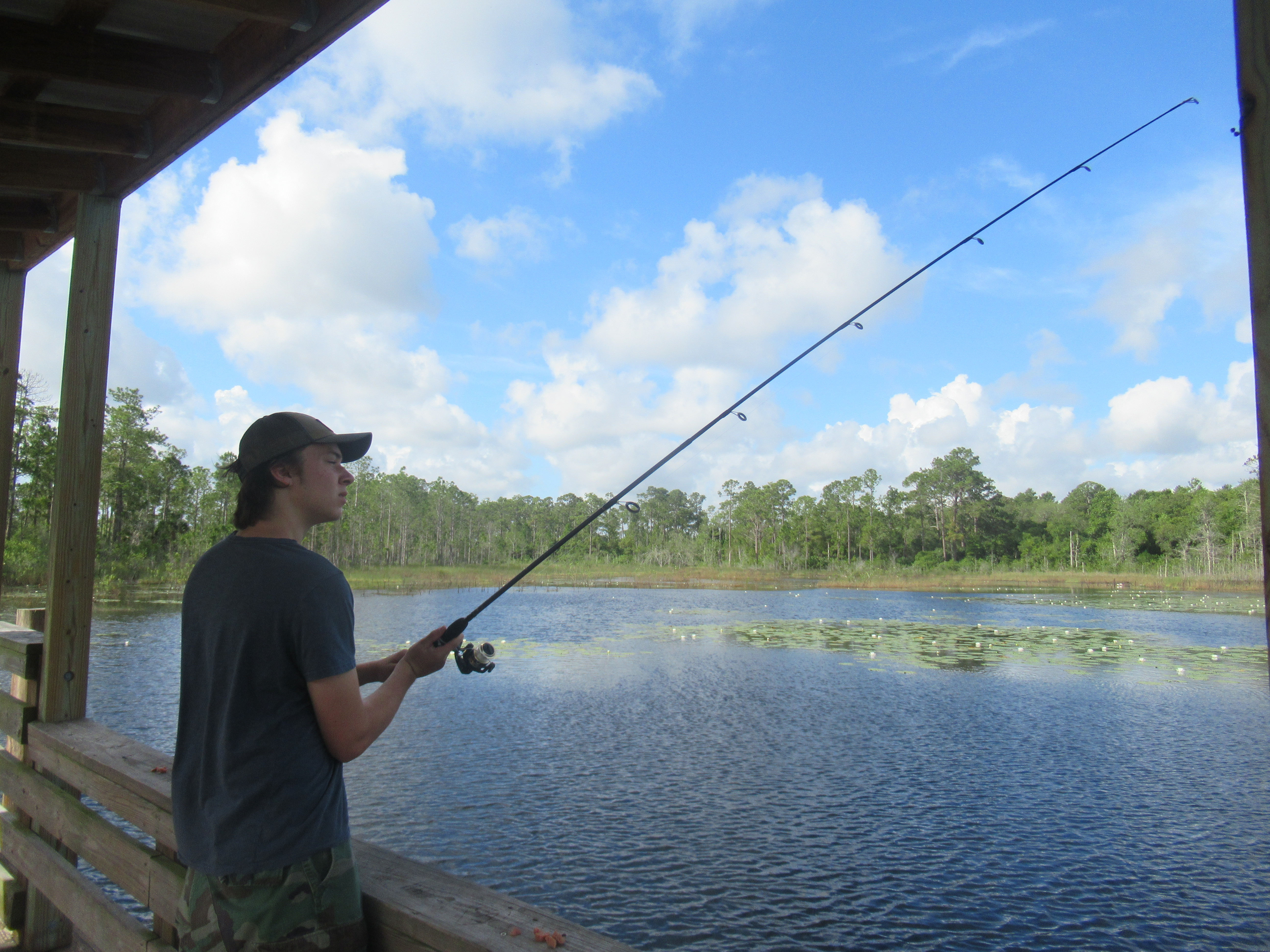 teen boy fishing on a dock