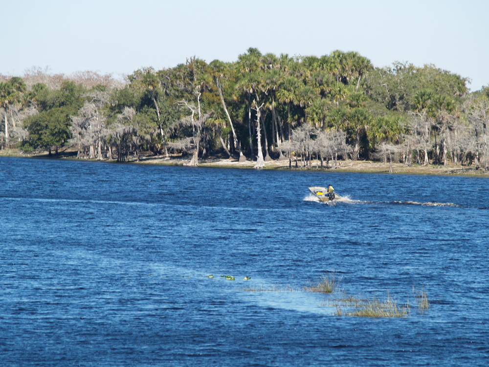 a boater out on a lake on a sunny day