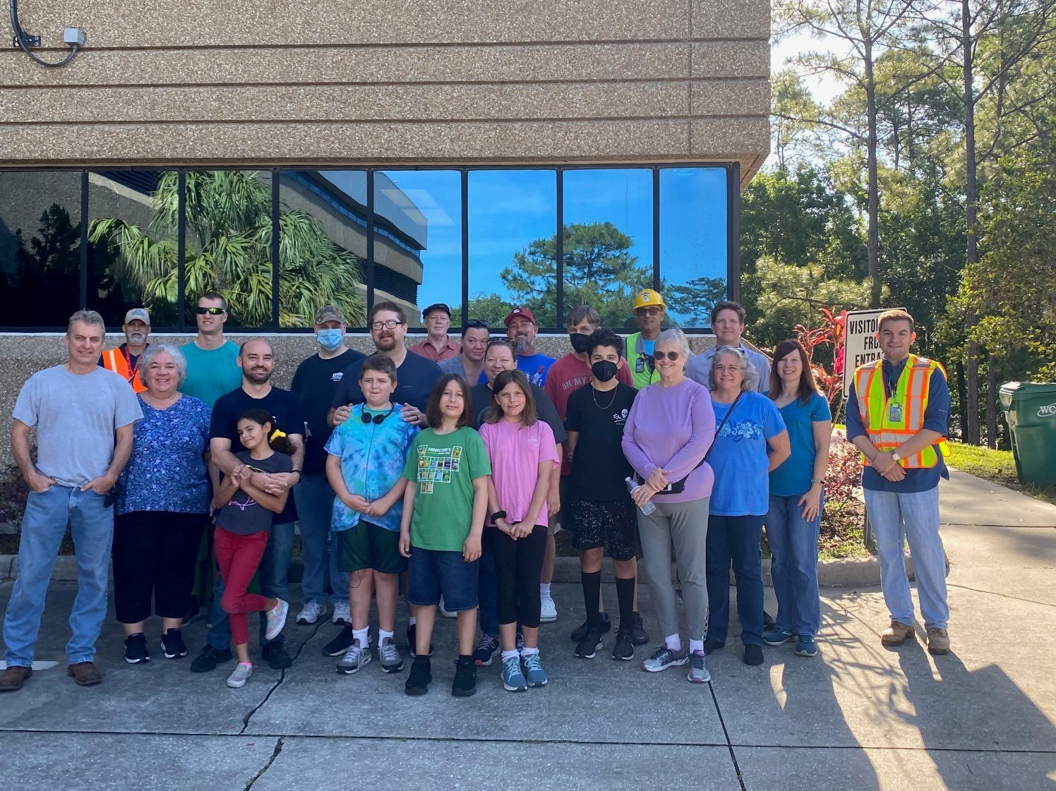 a group of seminole county solid waste management employees and children standing in front of a solid waste facility