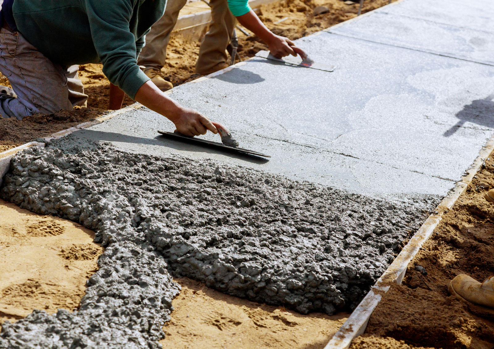 men-finishing-cementing-sidewalk