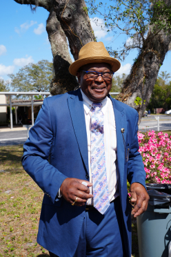 BBQ-stylish-man-in-blue-suit-and-blue-framed-glasses-smiles-for-camera_thumb